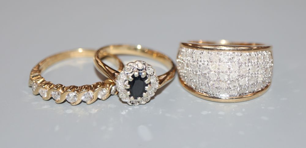 Two modern 9ct gold and diamond set dress rings and a 9ct gold sapphire and diamond cluster ring, gross 9.7 grams.